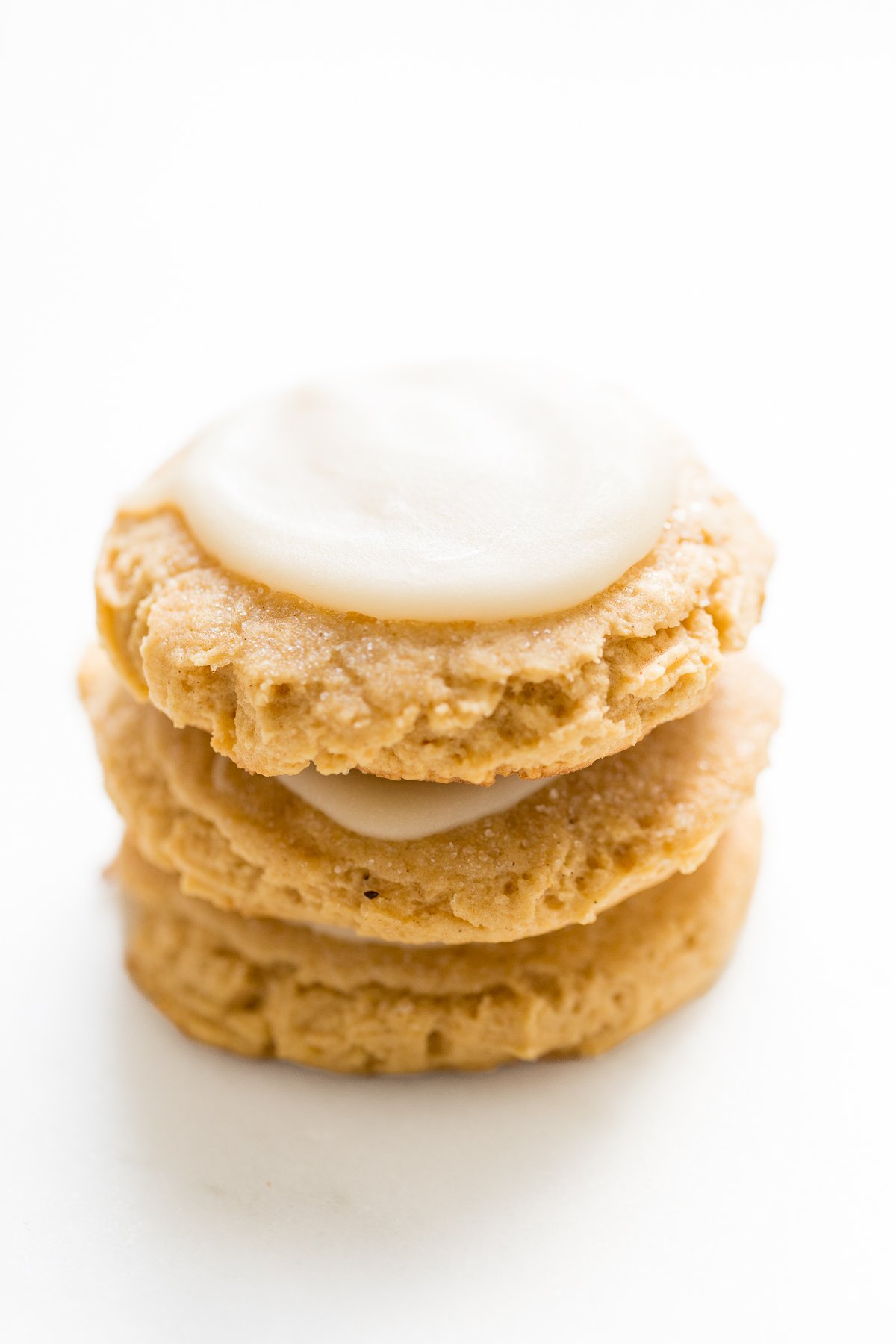 A stack of pumpkin spice sugar cookies with a cream cheese glaze.