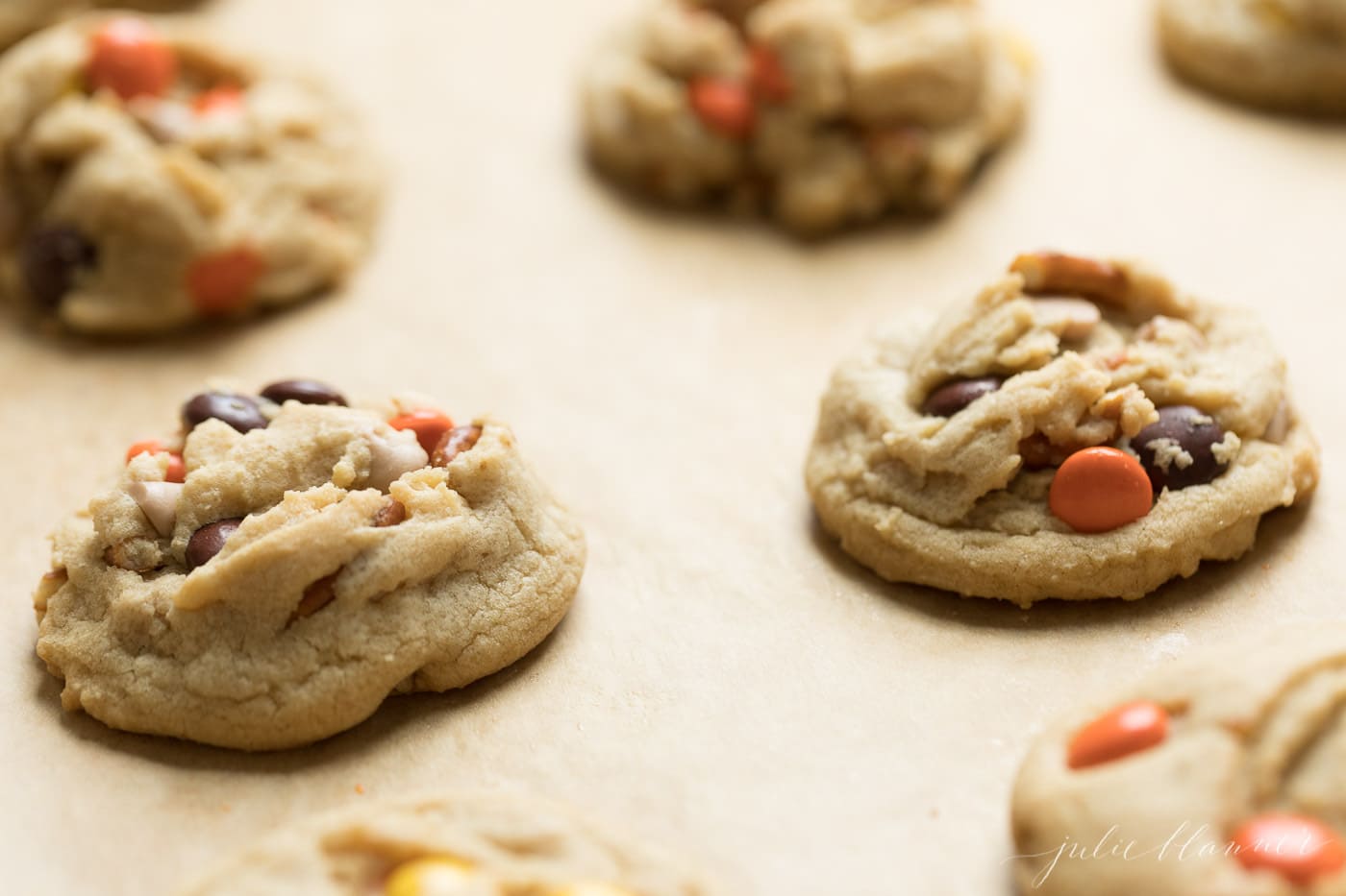 Monster Candy cookies for Halloween on a cookie sheet with parchment paper.