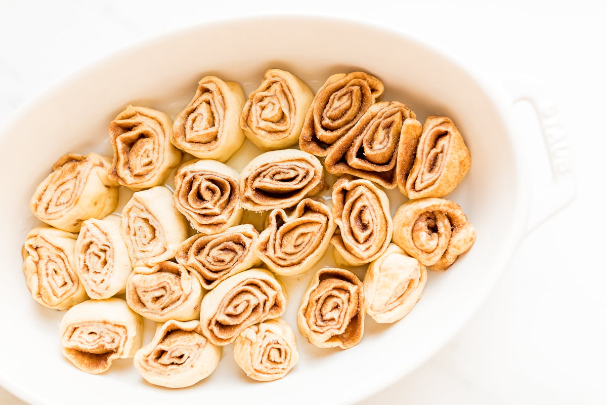 Cinnamon rolls made with crescent rolls in a white oval dish.