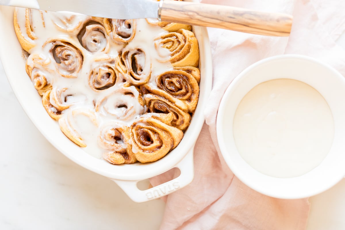 Cinnamon rolls made with crescent rolls in a white oval dish.