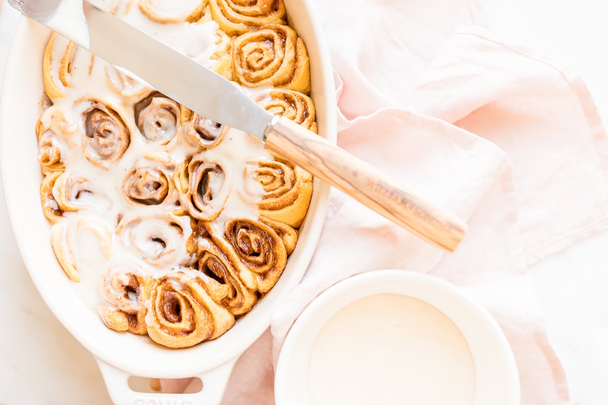 Cinnamon rolls made with crescent rolls in a white oval dish.