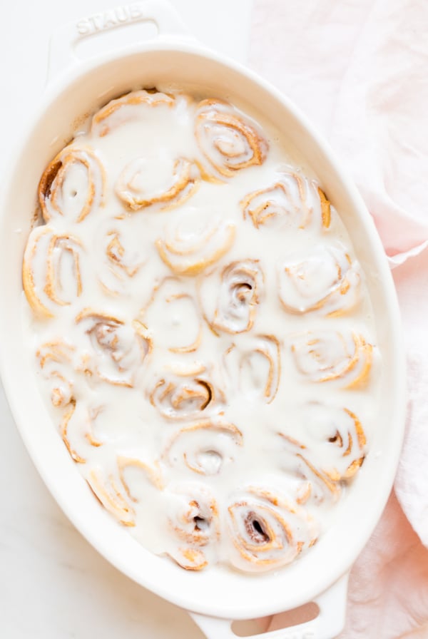 Cinnamon rolls made with crescent rolls in a white oval dish.