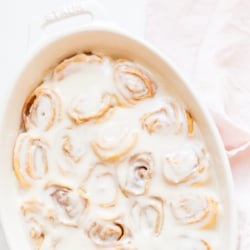 Cinnamon rolls made with crescent rolls in a white oval dish.