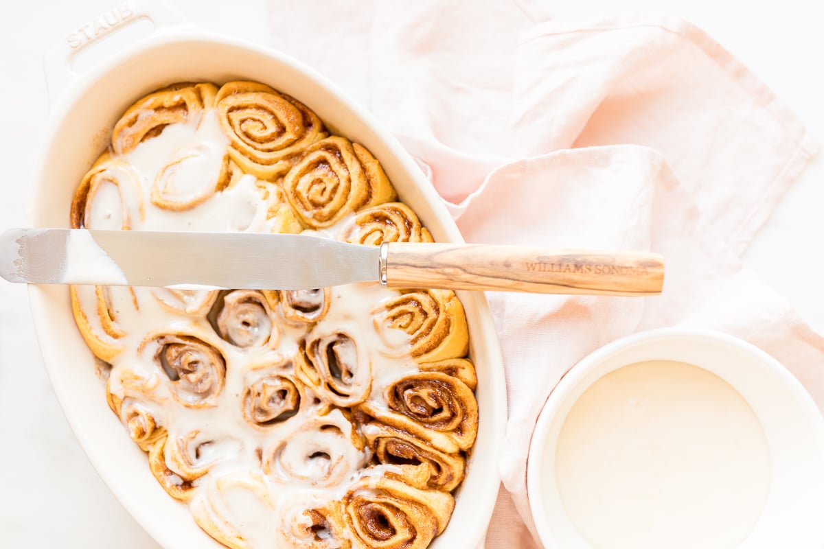 Cinnamon rolls made with crescent rolls in a white oval dish.