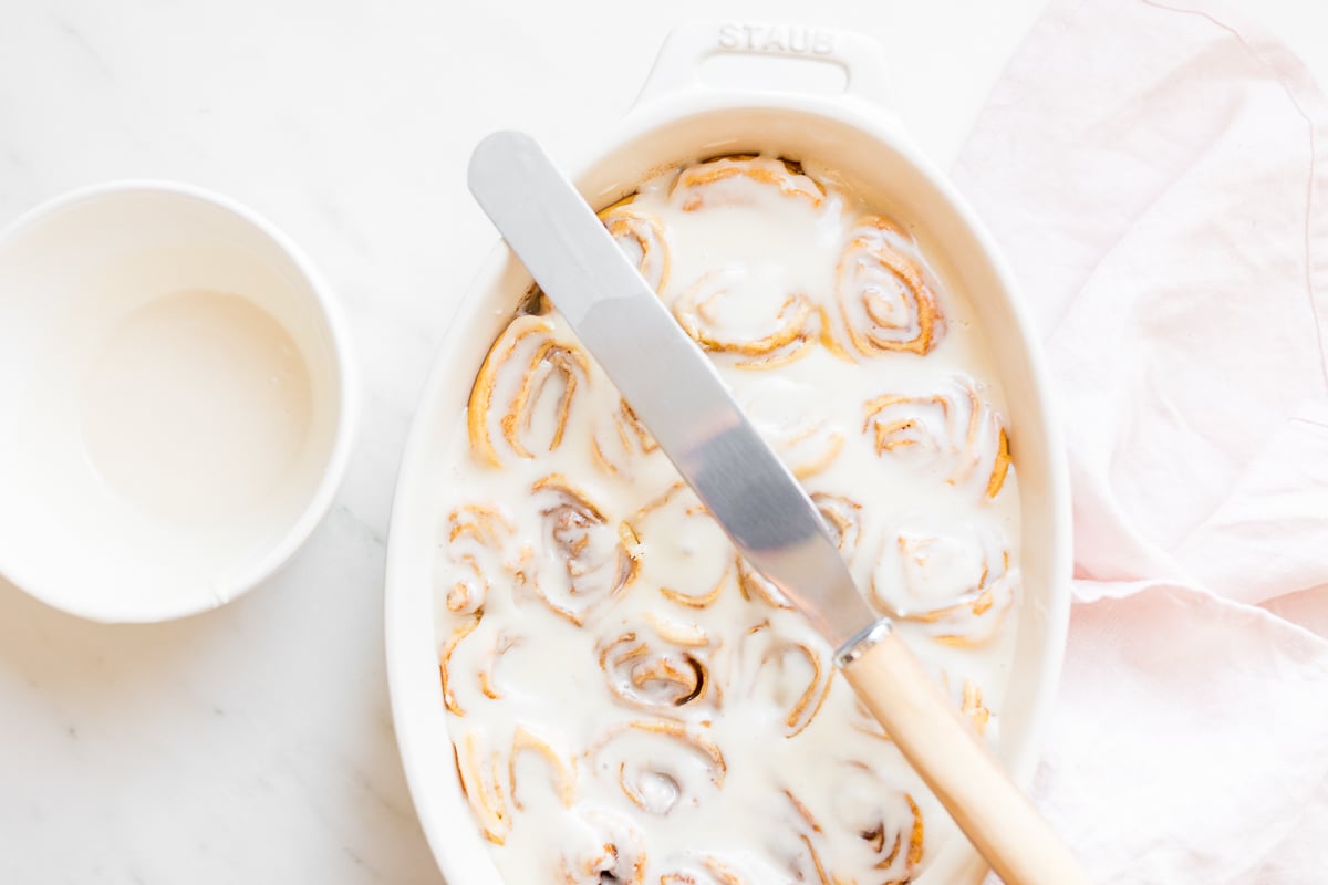 Cinnamon rolls made with crescent rolls in a white oval dish.