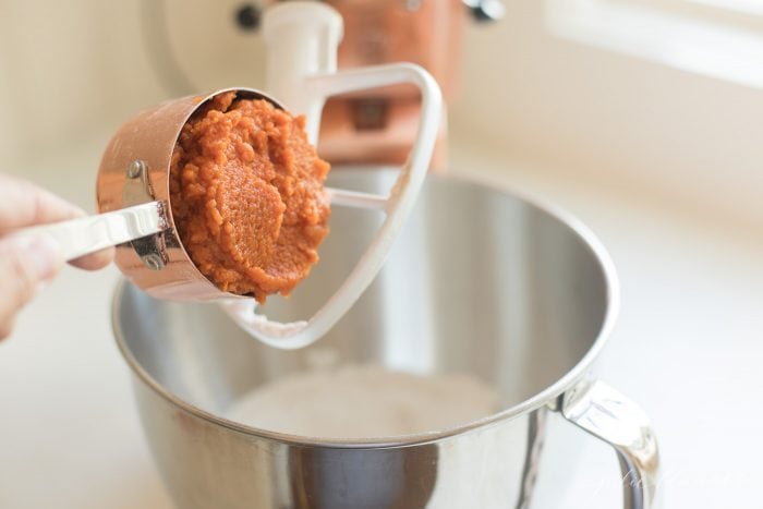 Pumpkin puree being added to the mixer