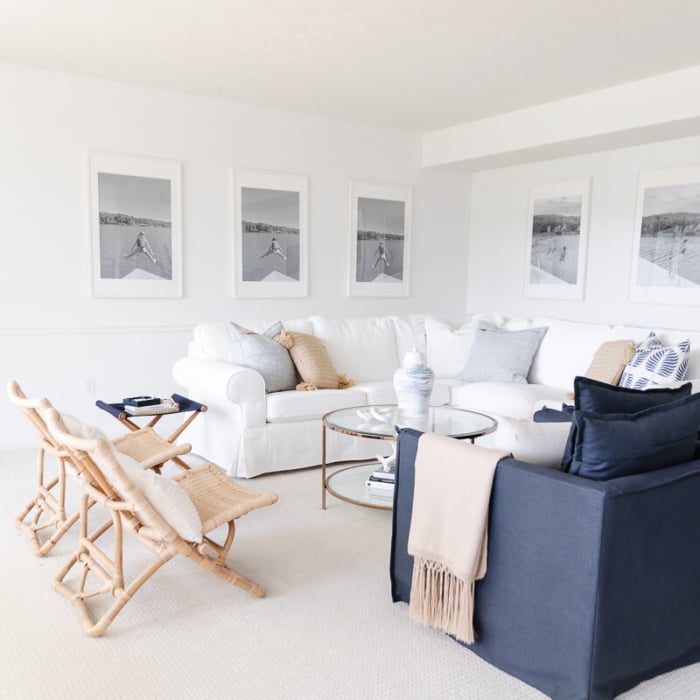 A white living room with wall to wall carpet.