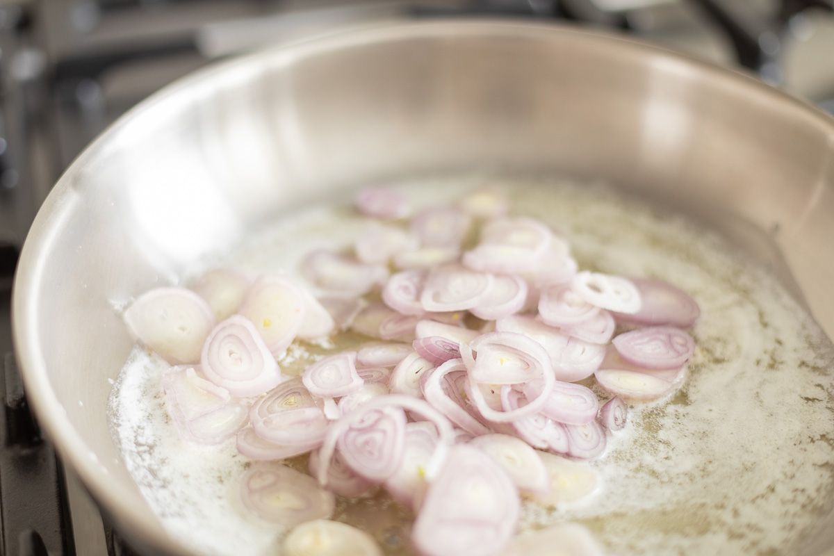 Shallots in a pant, being caramelized