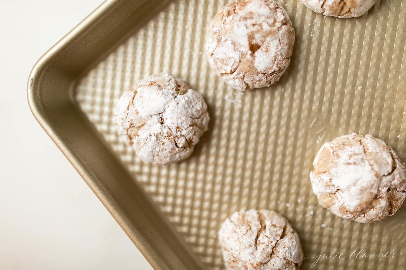 Top shot of gooey butter eggnog cookies on a baking sheet