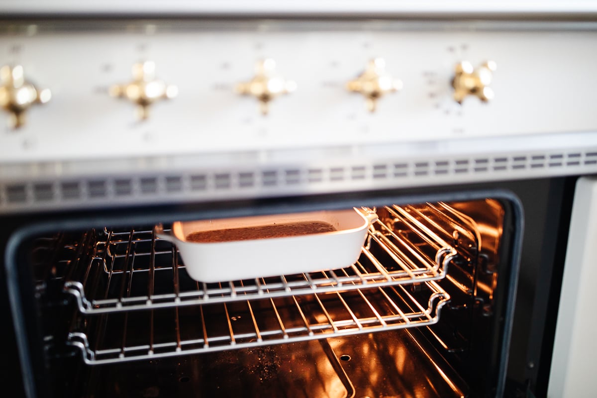 An oven with caramel pecan sticky rolls baking inside.