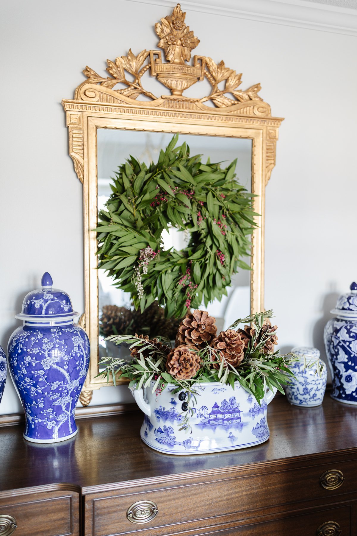 A Christmas mirror on a dresser in a house.