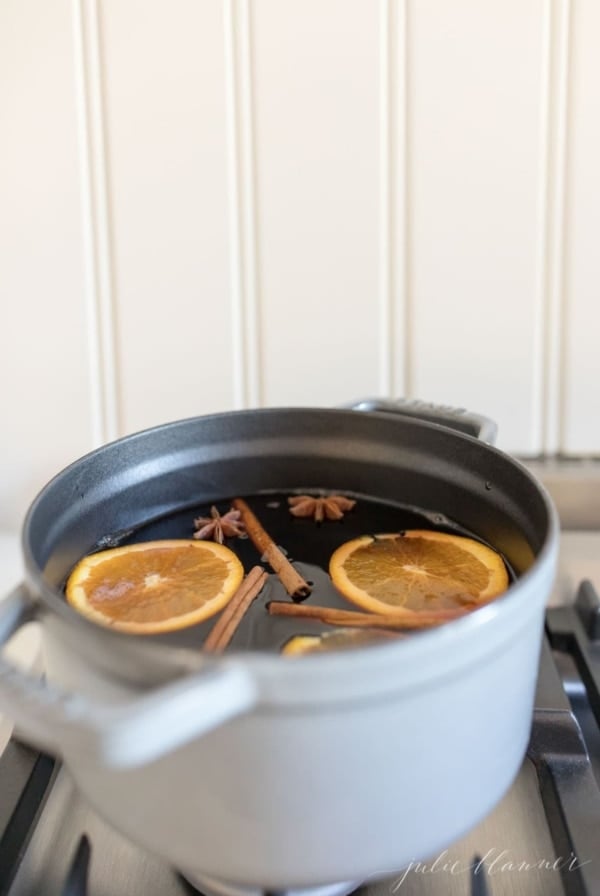 non alcoholic mulled wine recipe in a gray dutch oven on the stovetop