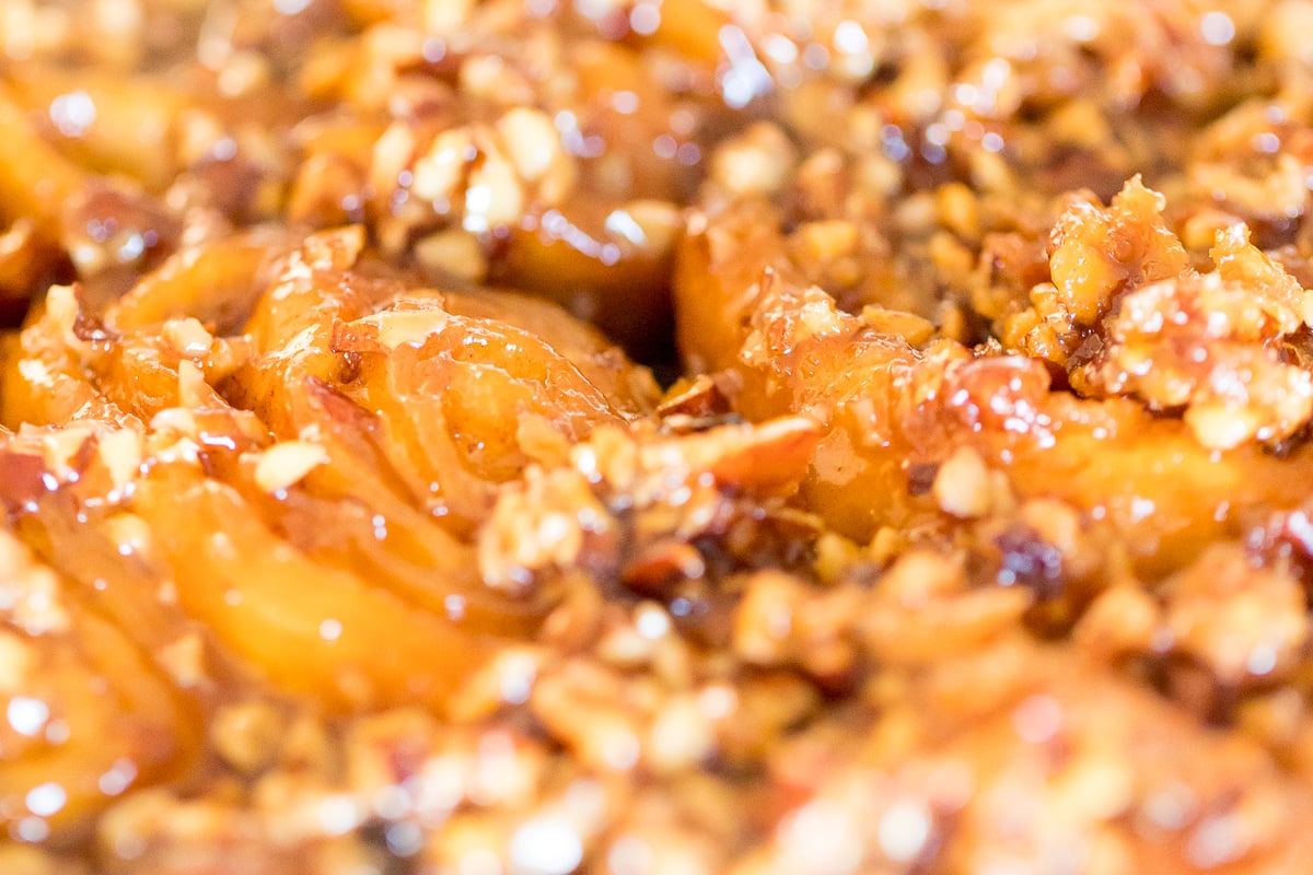 A close up of a piece of Caramel Pecan Sticky Rolls.