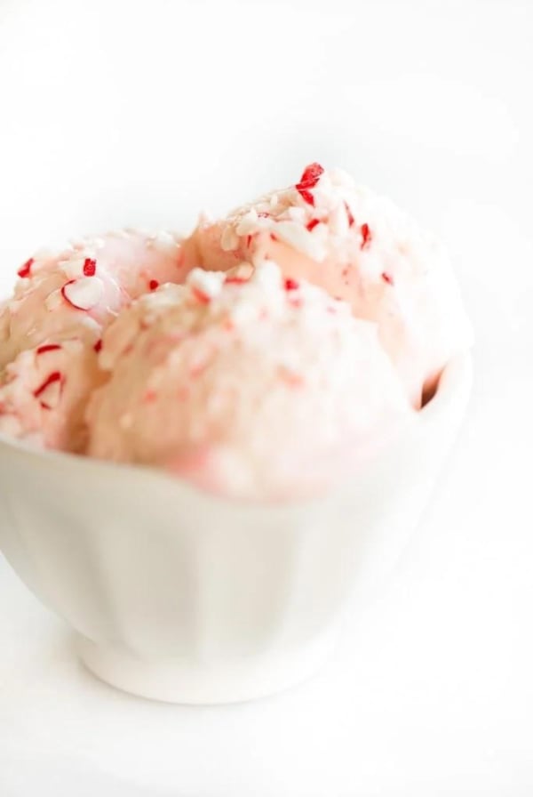 Peppermint stick ice cream in a white bowl.