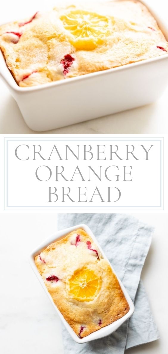 Small ceramic loaf pan of cranberry orange bread, resting on a pale blue linen towel.