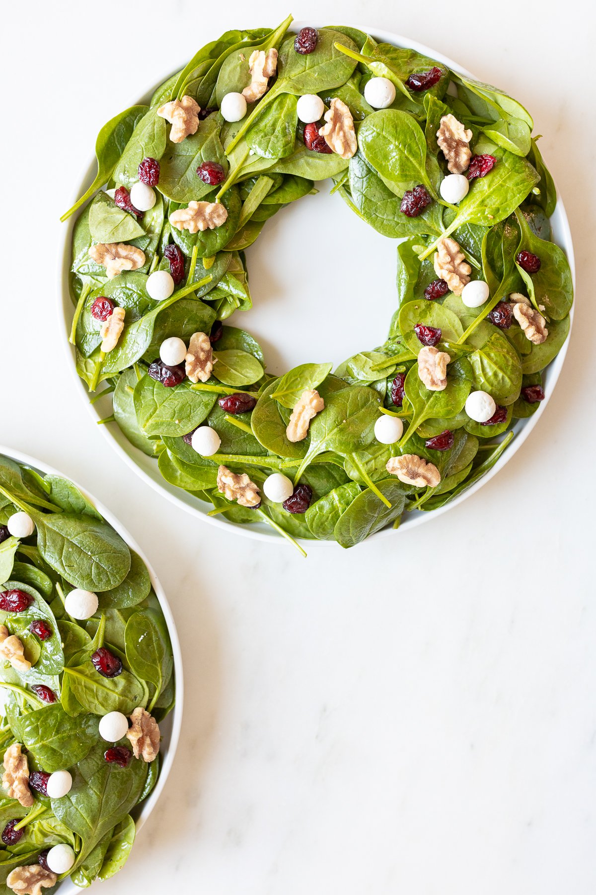 Christmas Salad with spinach, walnuts, and cranberries.