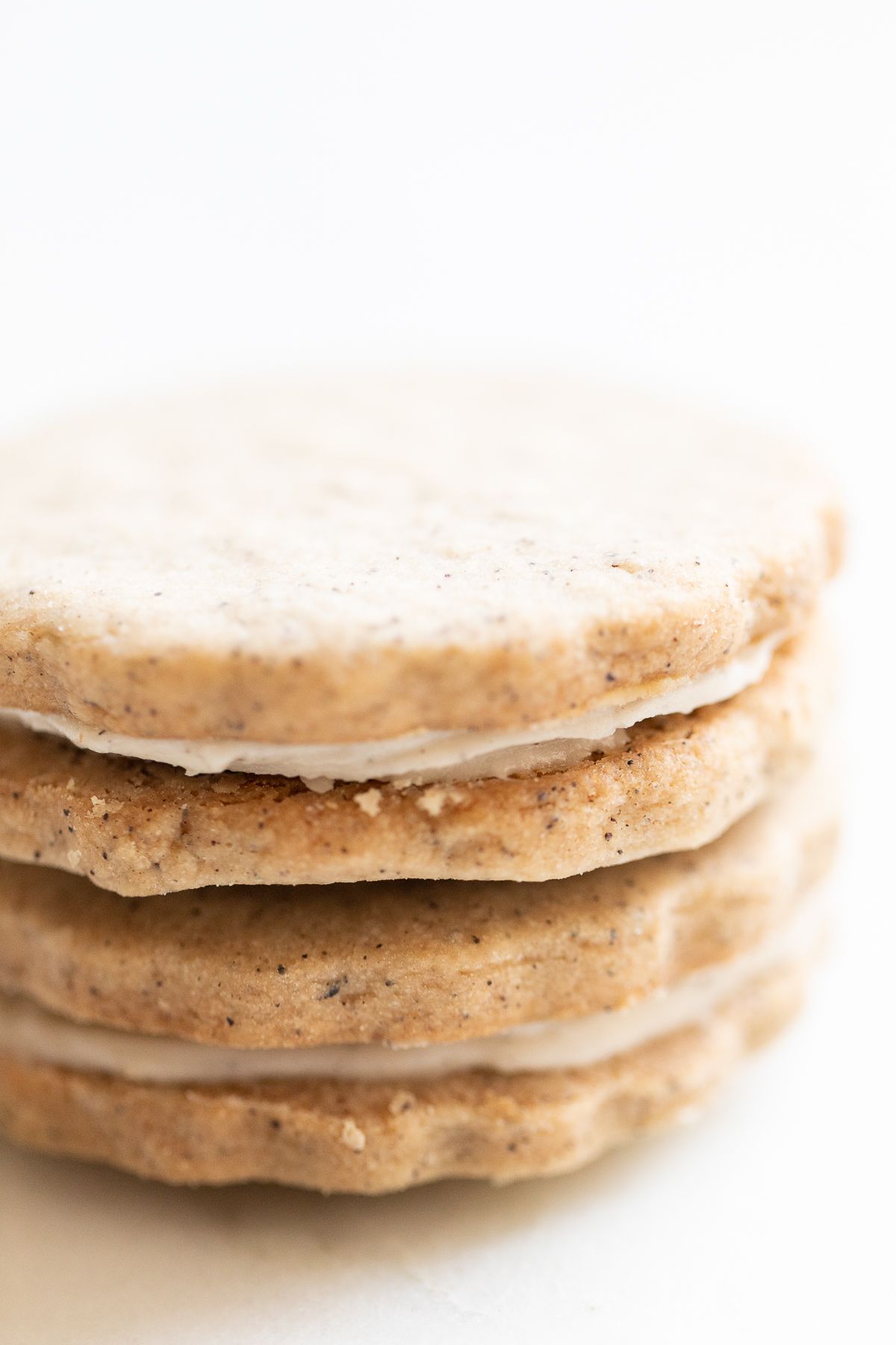 Espresso cookies stacked on a marble countertop.