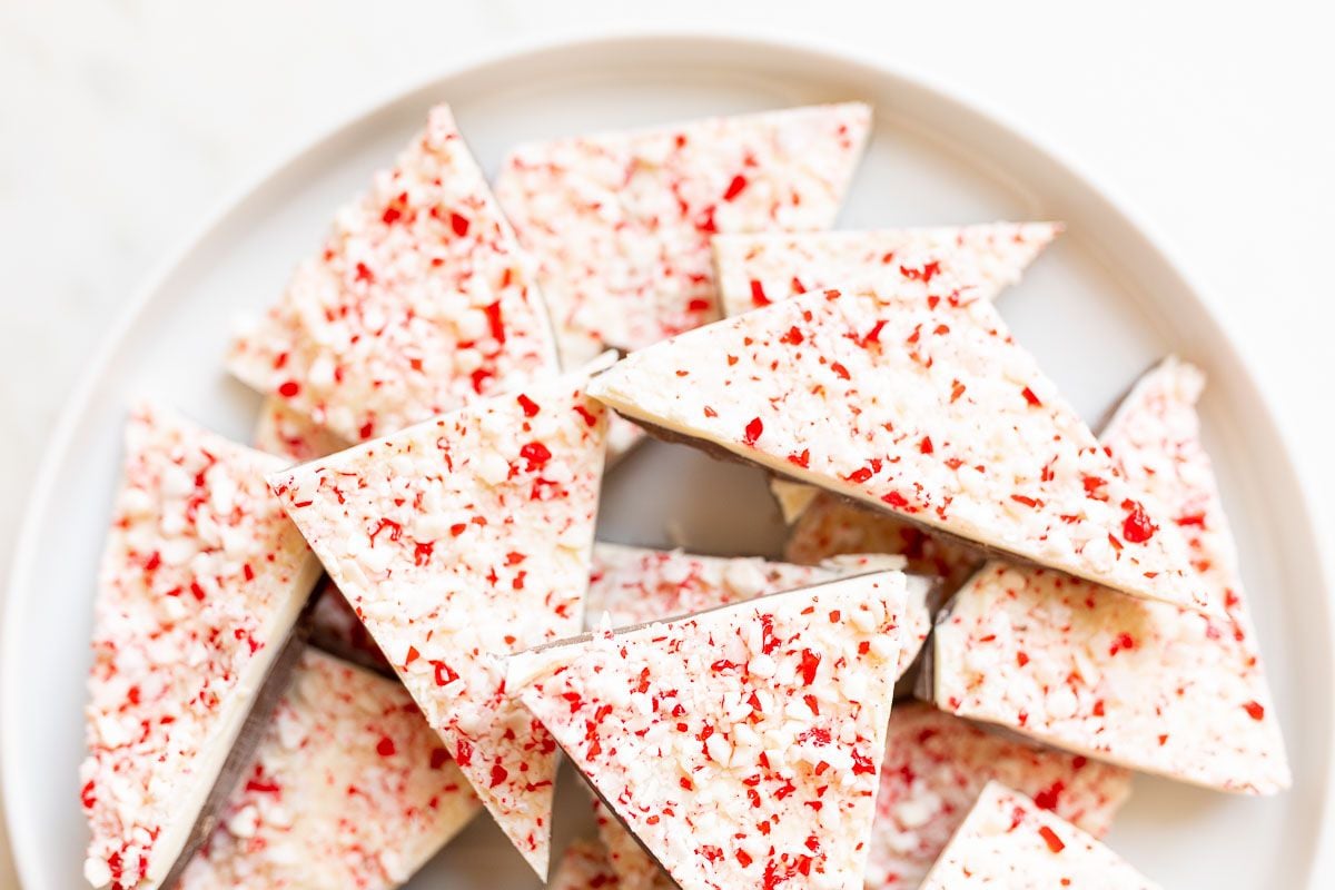 Chunks of salted peppermint bark on a white serving platter.