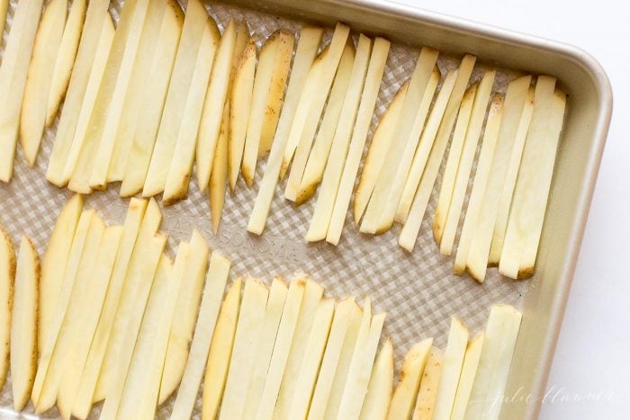 sliced potatoes on a sheet pan