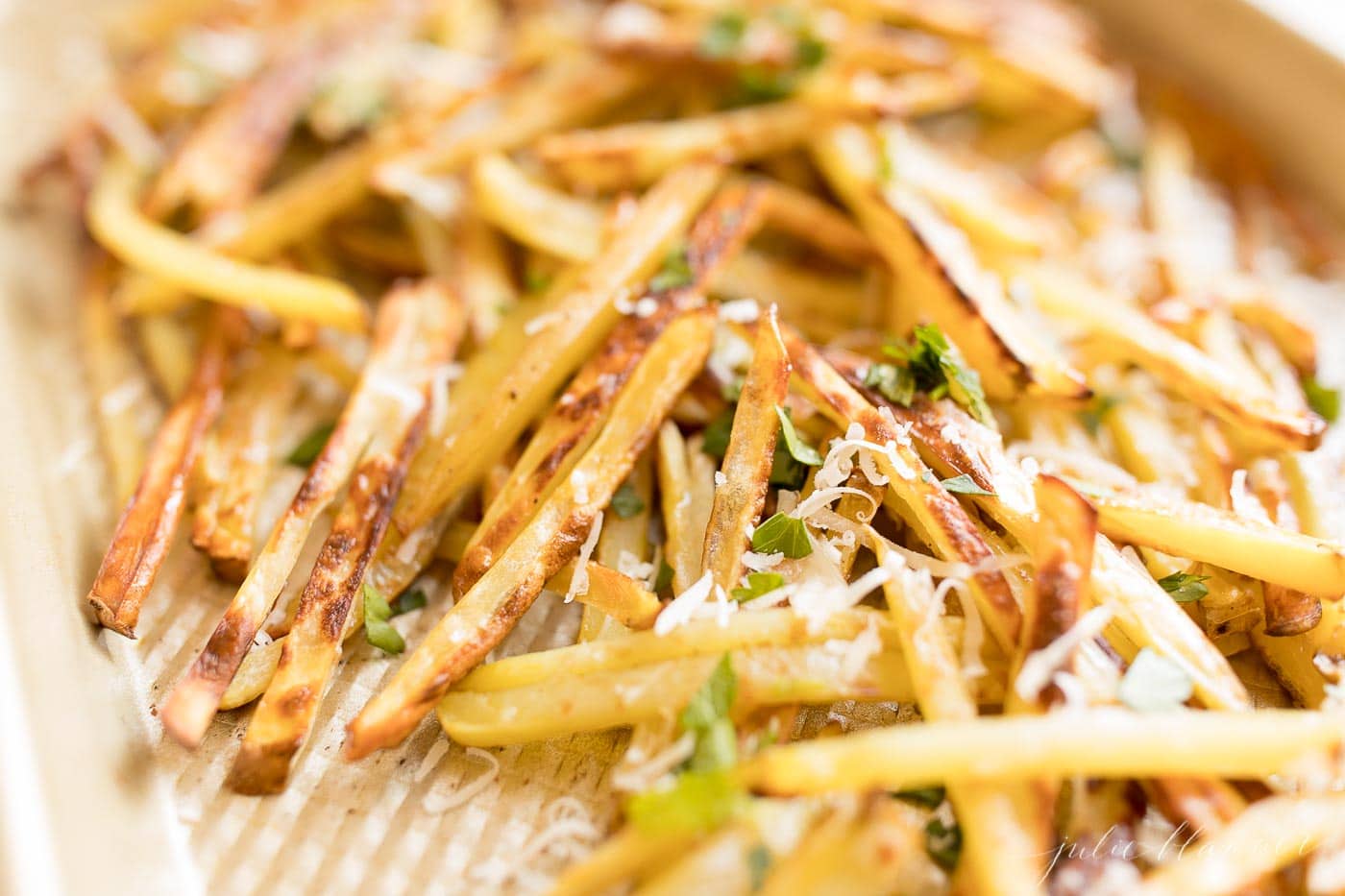 fries with Parmesan and parsley on a sheet pan