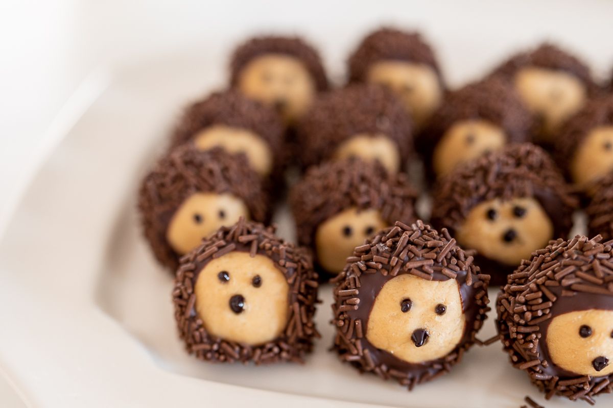 A buckeye recipe shaped into little hedgehogs, on a white platter.