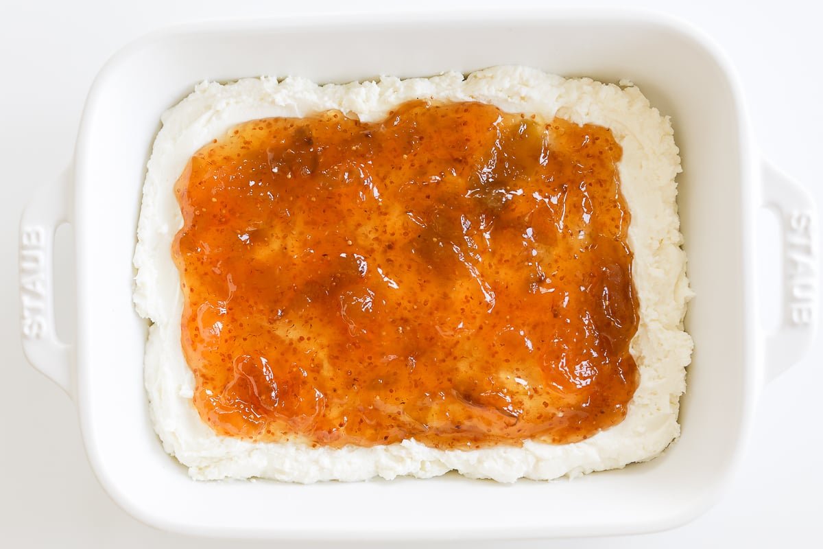 A white dish with pistachio goat cheese spread.