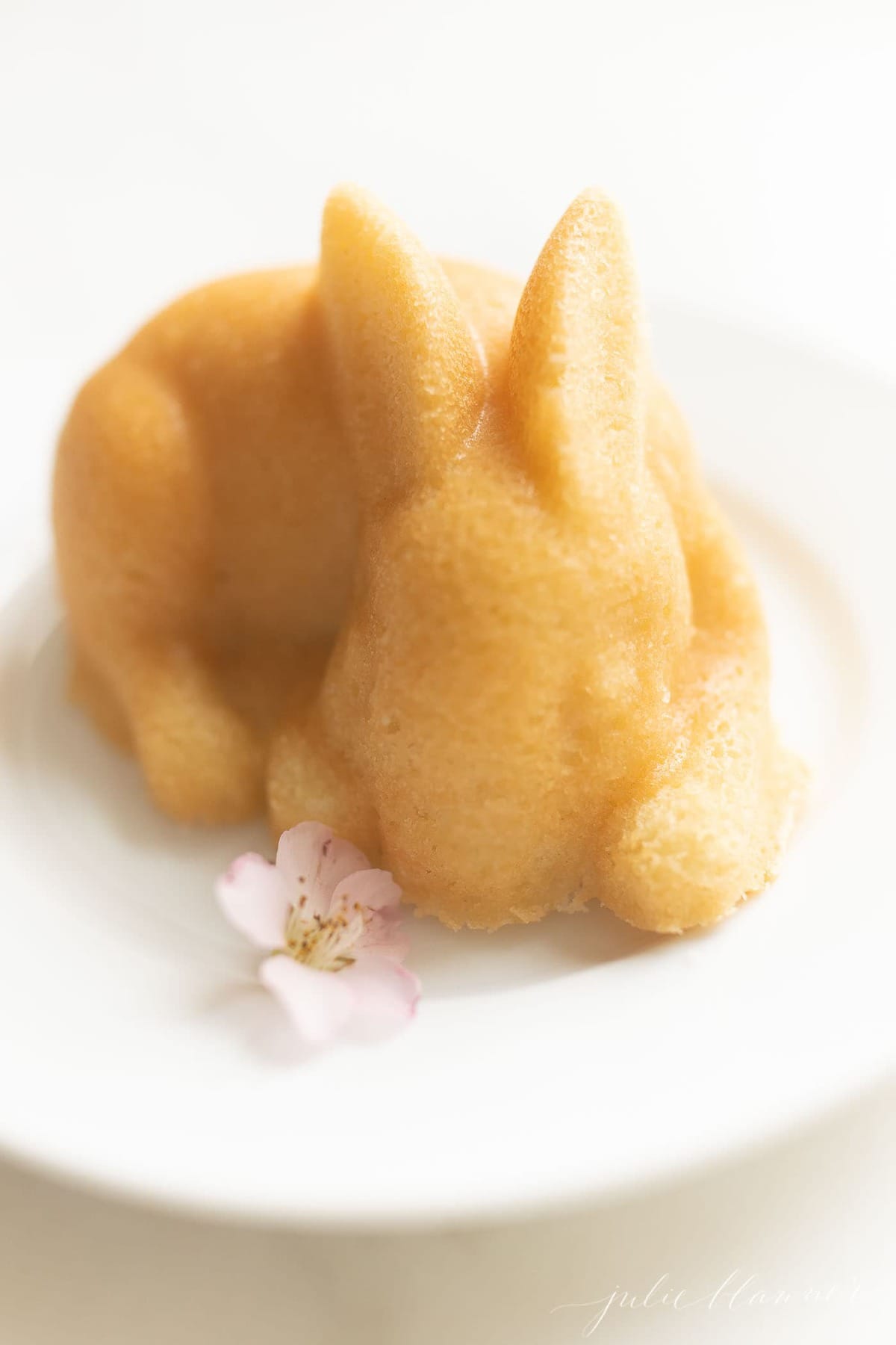 bunny easter cake on white plate with flower