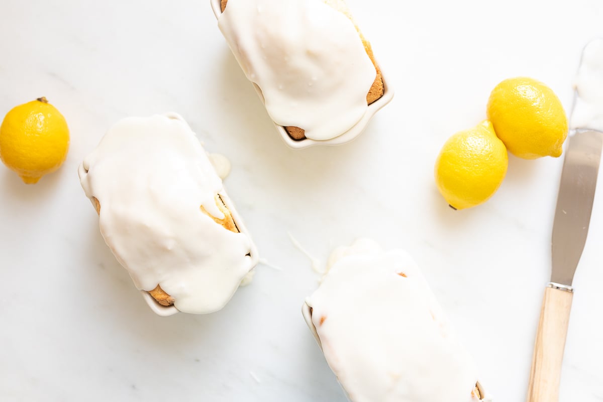 Mini lemon loaves on a white countertop.