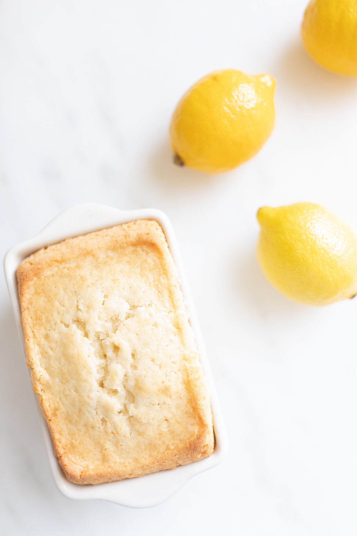 Mini lemon loaves on a white countertop.