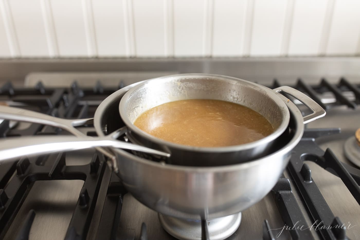 The honey glaze for ham in a saucepan on top of the stove