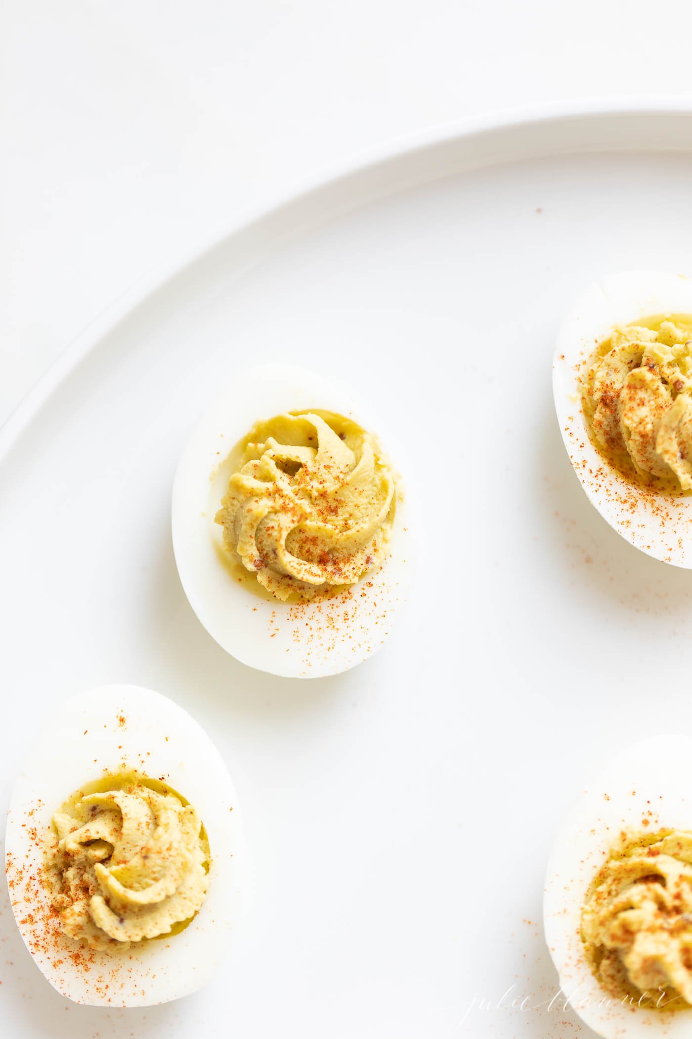 avocado deviled eggs on a serving platter