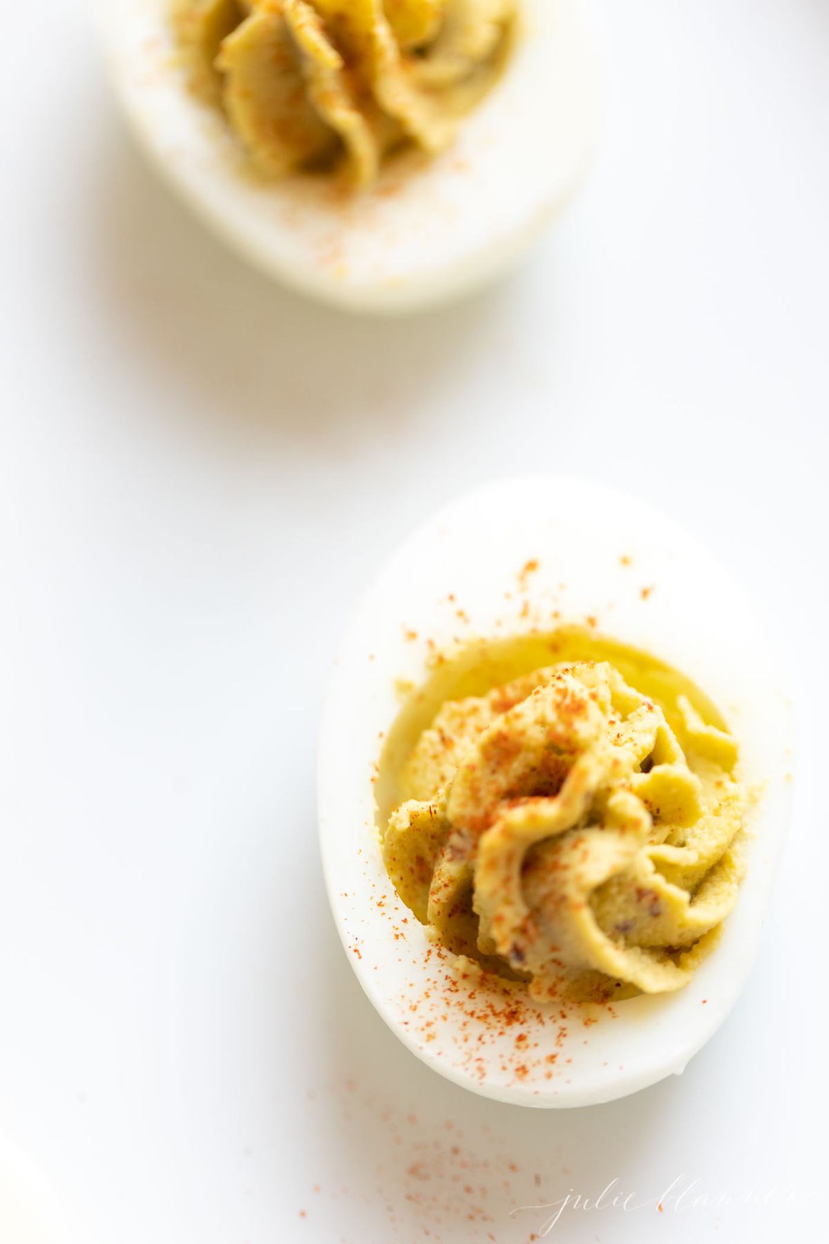 avocado deviled eggs on a white surface. 