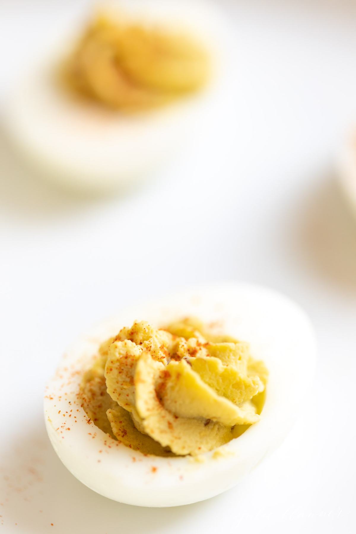 deviled avocado egg piped into boiled egg white