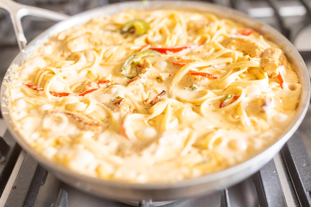 A skillet full of Cajun chicken pasta.