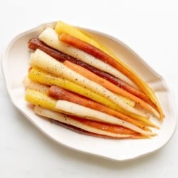 Candied carrots in a white serving dish