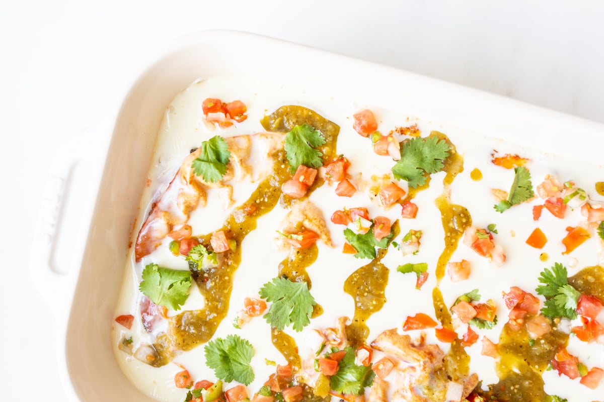 Chorizo burrito Mexican breakfast casserole in a white baking dish.