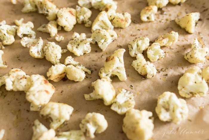 garlic and herb roasted cauliflower on a sheet pan