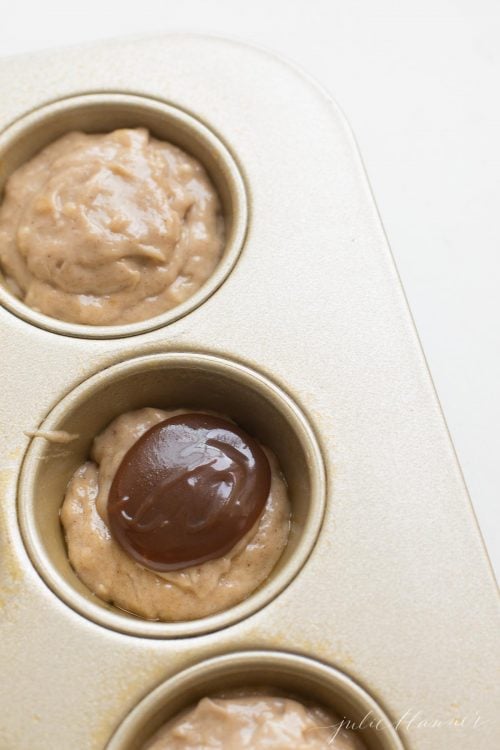 Caramel being put in the center of the Banana Muffin batter.