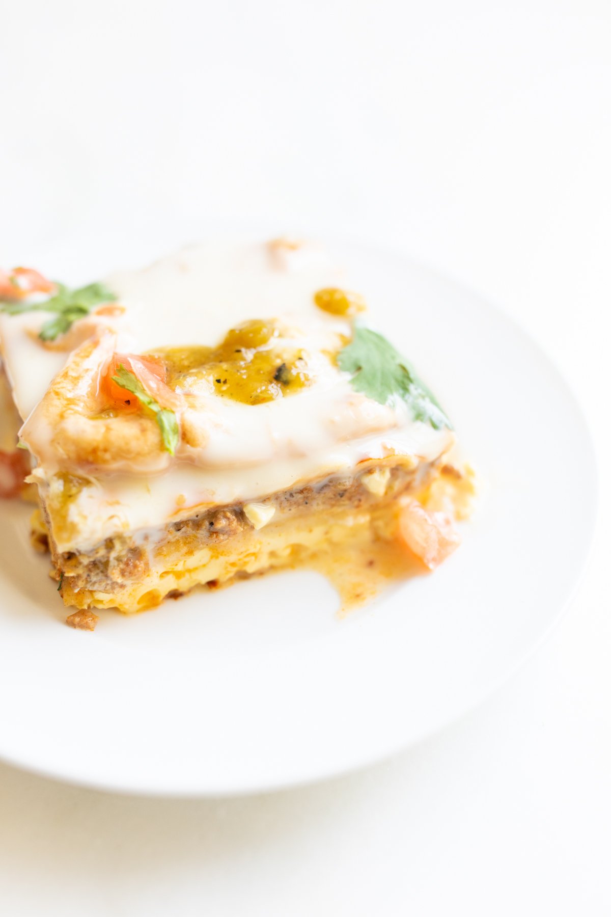 A slice of Mexican breakfast casserole on a white plate.