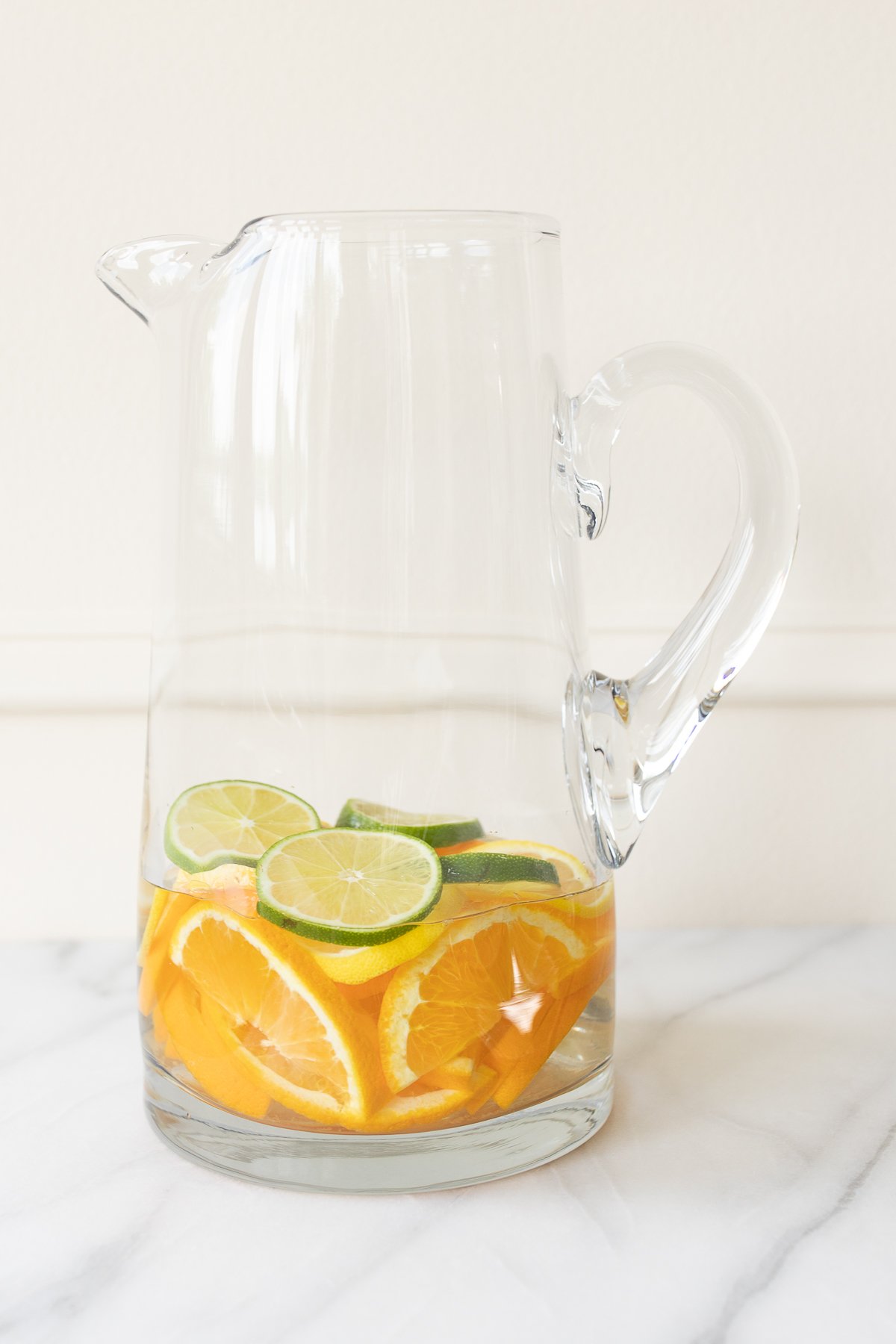 A glass pitcher full of fruit for red sangria