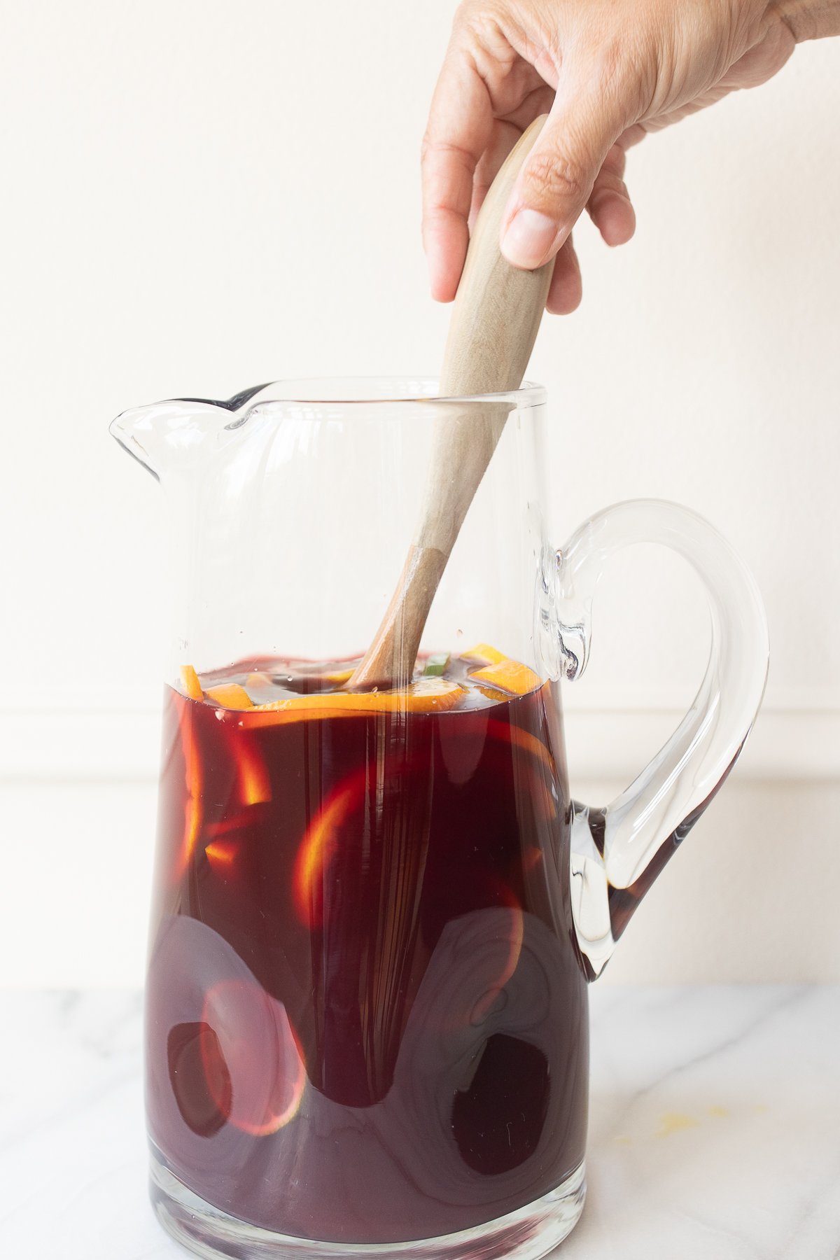 A glass pitcher full of red sangria.