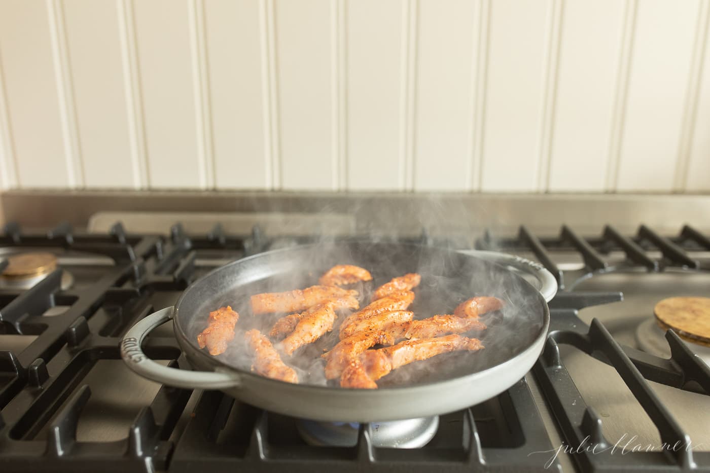 cajun spiced chicken cooking in a cast iron skillet