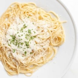 mizithra cheese and parsley on bed of spaghetti