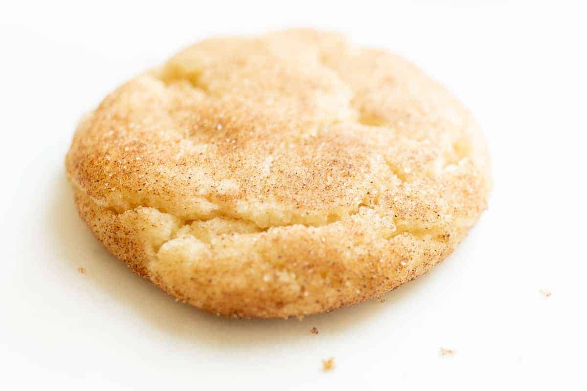 A snickerdoodle cookie on a white surface. 