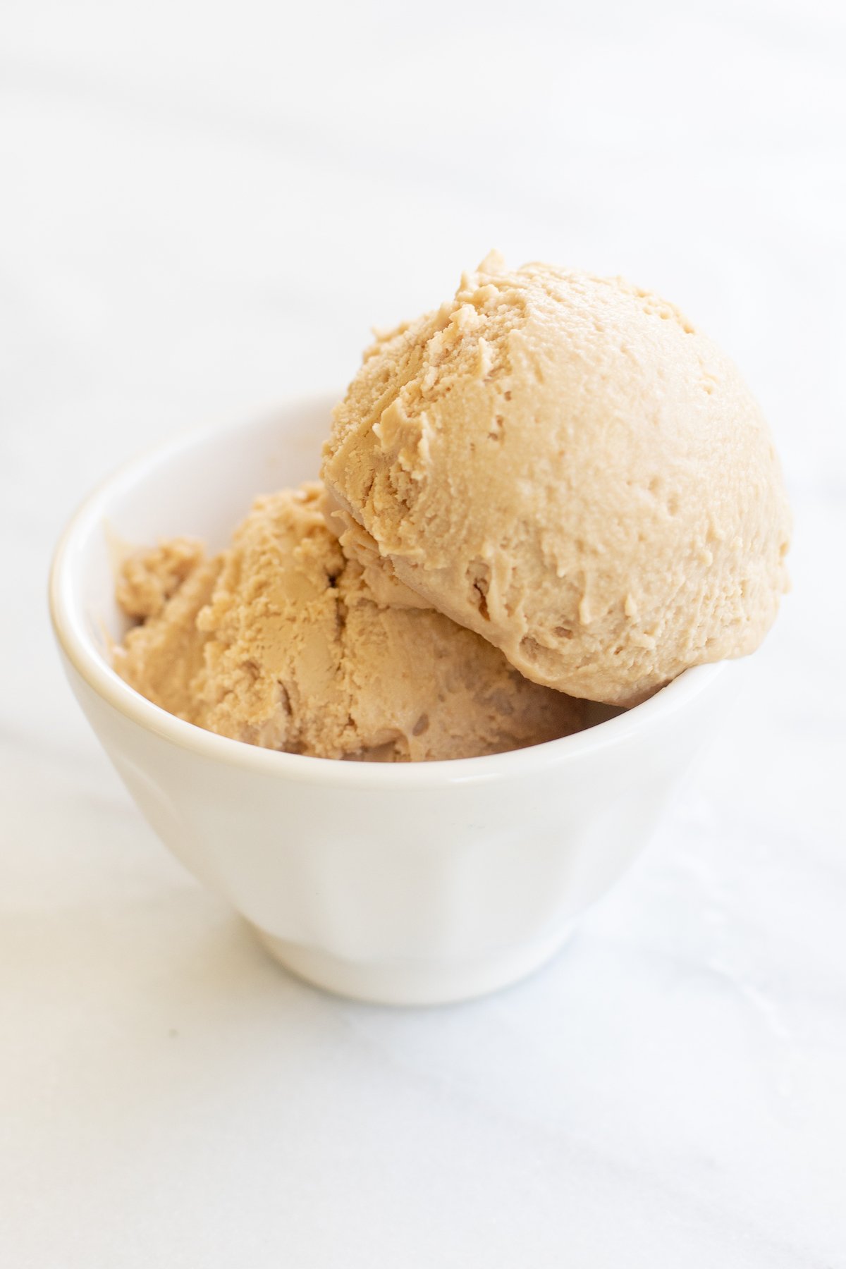 A white bowl full of homemade cookie butter ice cream.