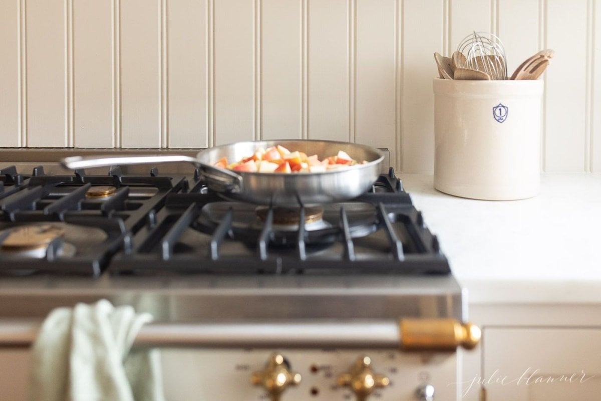 Apple crisp filling in a pan on a stove top.