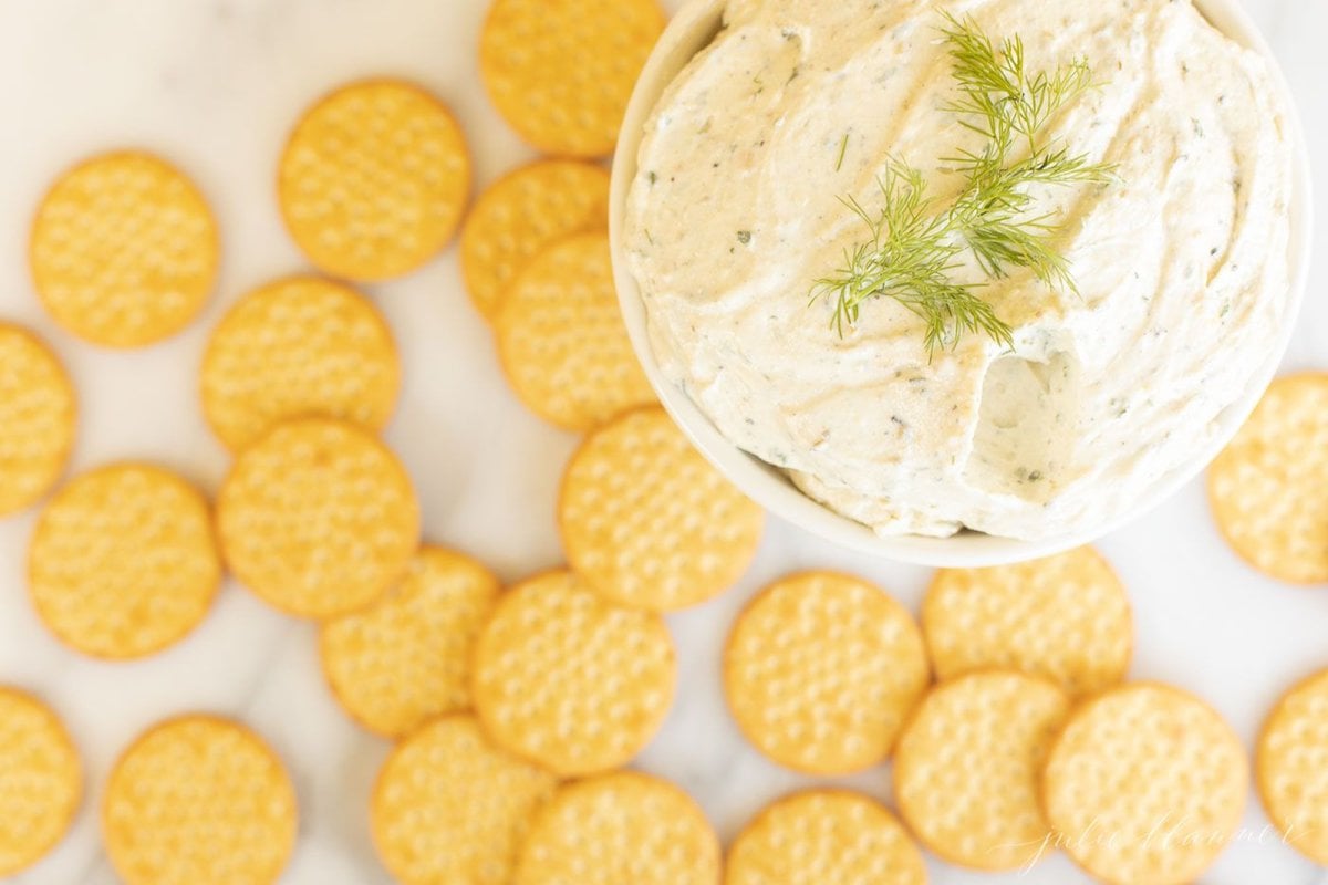 A white plate filled with crackers and homemade Boursin cheese.