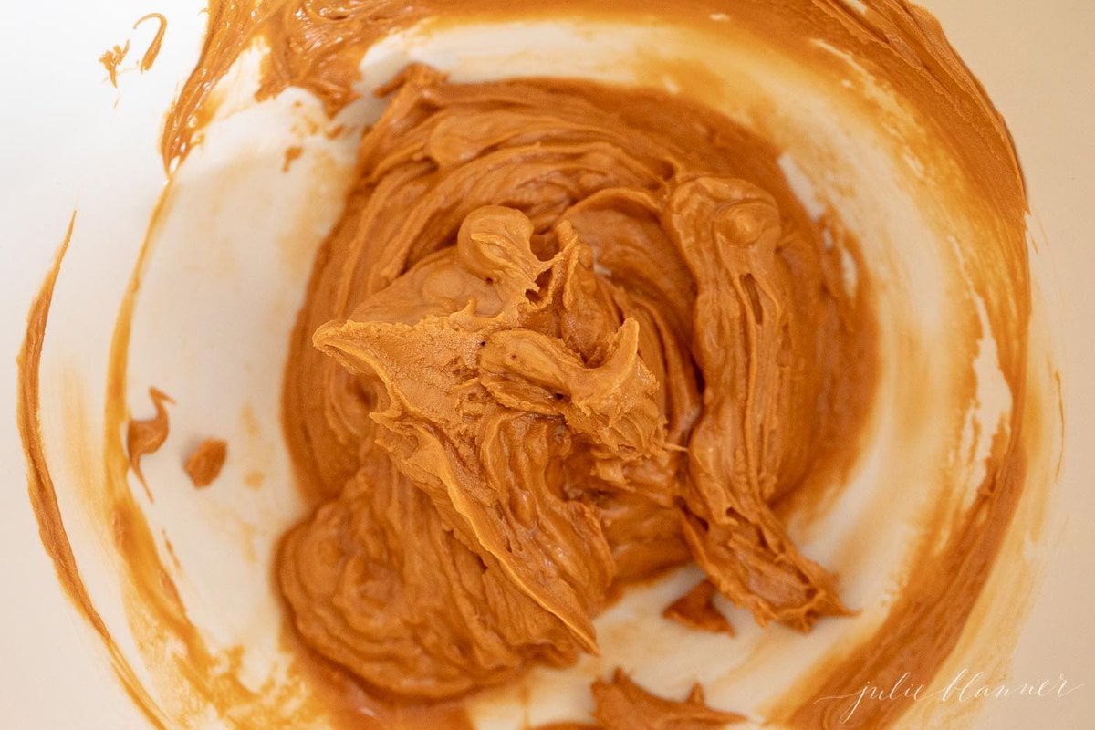 Butterscotch cake batter inside the bowl of a stand mixer.