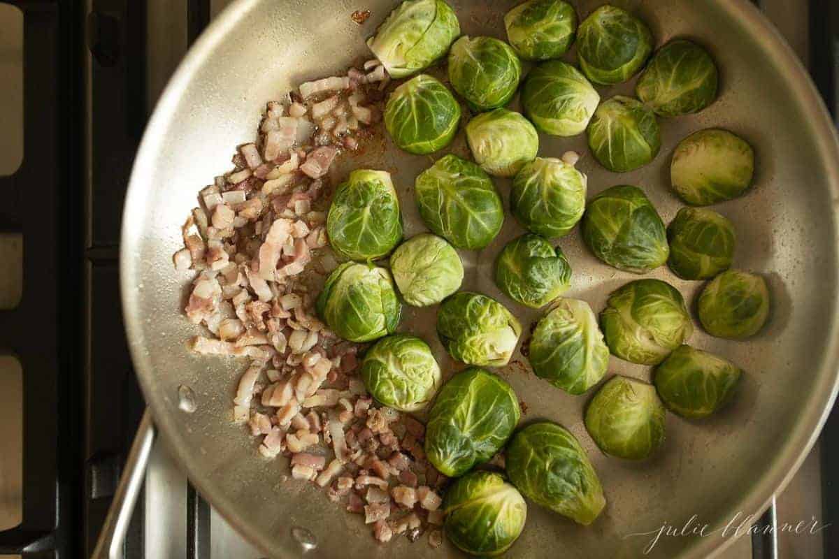 Aluminum pan on the stovetop, fresh pancetta and brussel sprouts waiting to be cooked.