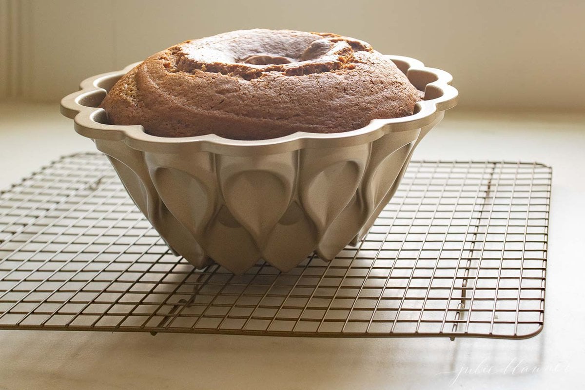 A pumpkin bundt cake on a wire cooling rack.